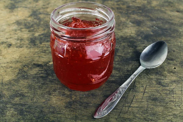 Fresh strawberry jam in glass bottle with mint leaf — Stock Photo, Image