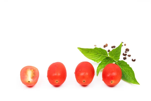 Tomates cereja com folha de manjericão em um fundo branco — Fotografia de Stock