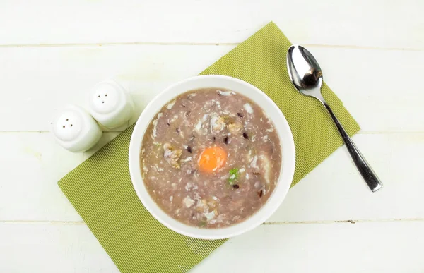 Homemade rice berry rice soup with egg in a Bowl