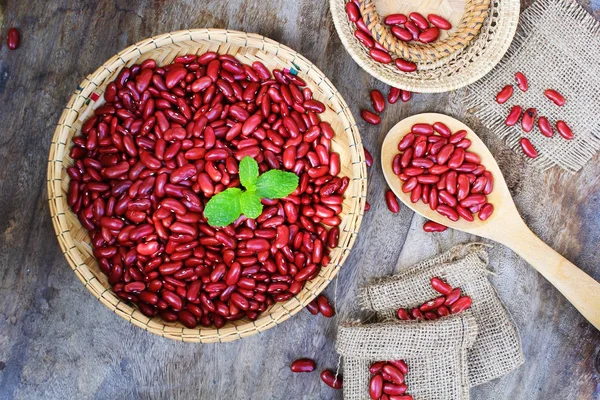 Red kidney bean on rattan cup on wooden background