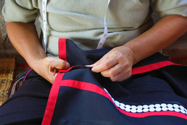 Women are sewing, tribal dress, Phuthai dress