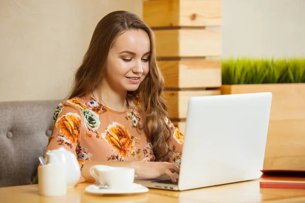 girl smiling printing at the laptop