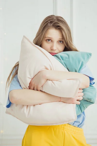 Just woken up girl without make up stands with pillows — Stock Photo, Image