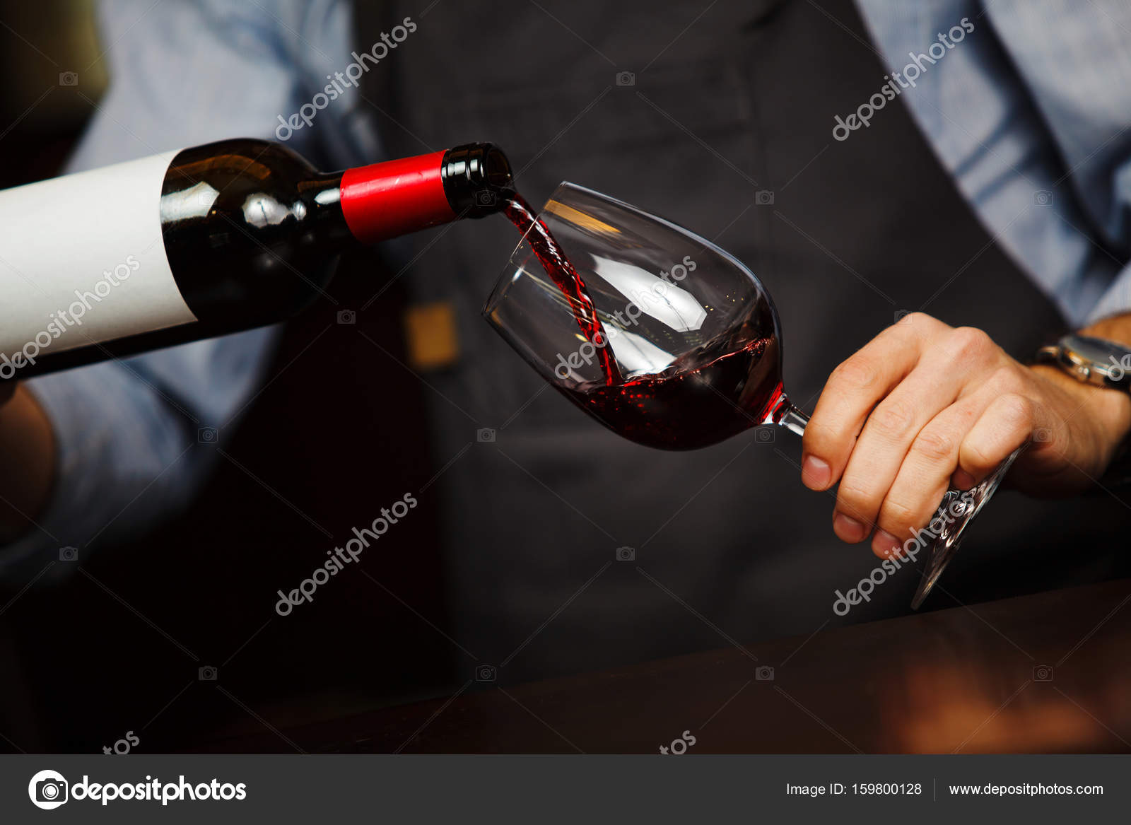 Hand Pouring Glass Of Wine