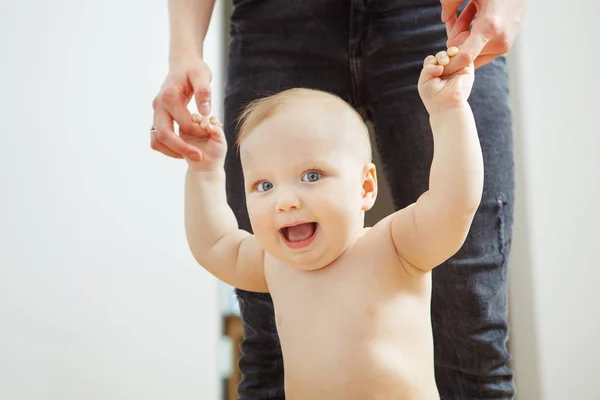 Happy child with wide open mouth learning to walk. — Stock Photo, Image