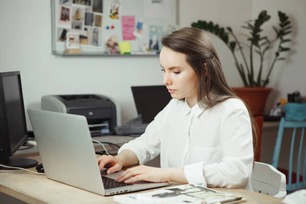 Serious woman in work at computer, attractive businesswoman