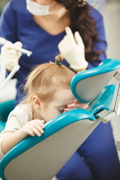 Little kid afraid of procedures in dentist office