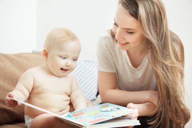 Peri masalları ile küçük bebek renkli kitap okuma anne.