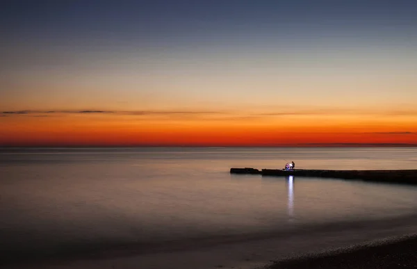日落码头渔夫在海海岸. — 图库照片