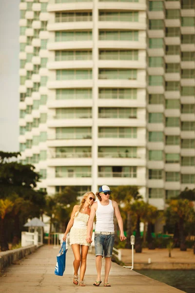 young couple walking on the pier to the sea. wedding honeymoon places. couples vacation.