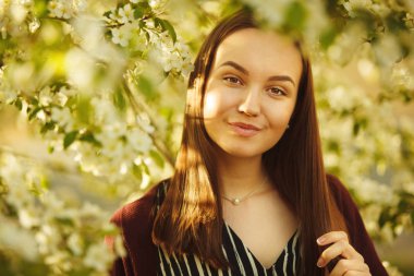 Temiz Cilt yakınındaki çiçek açan bir elma ağacı olan kadın. Bahar park kız portresi.