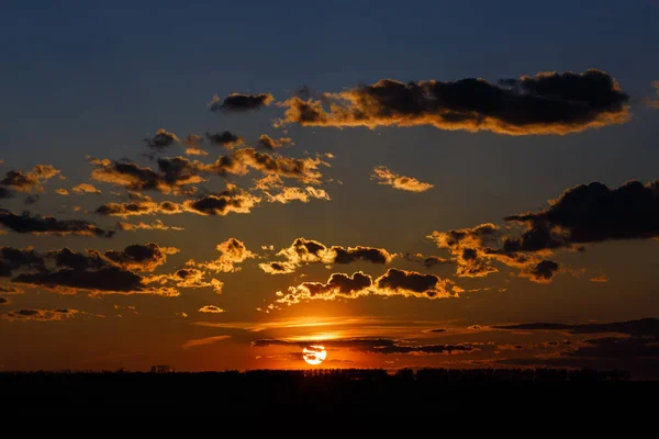 Orange sunset in the background air clouds and blue sky. — Stock Photo, Image