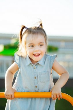 Çocuk parkta merdivenlerden tırmanıyor.