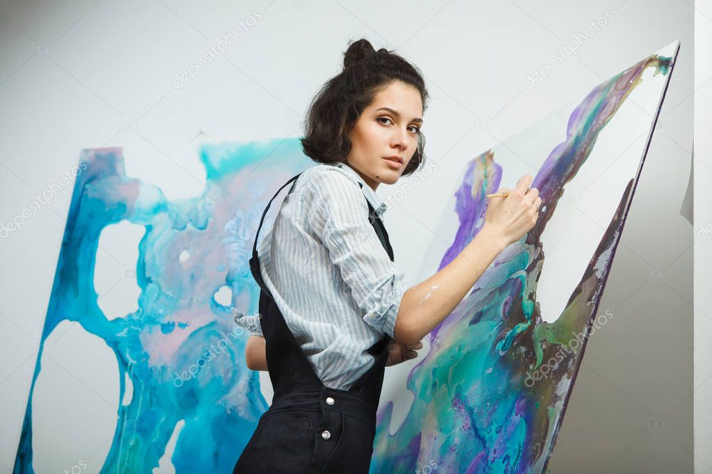 Concentrated girl focused on creative art-making process in art therapy