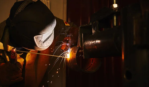 Close-up image of industrial worker at the factory welding.