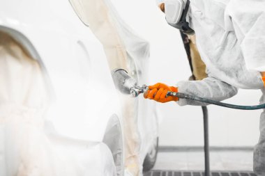 Application of primer before the main spray painting of the car.