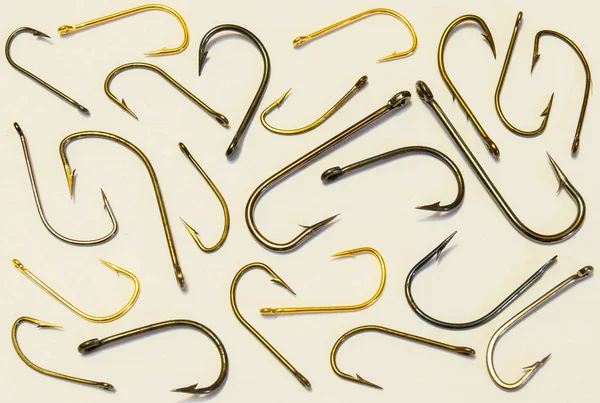 Many scattered fishing hooks on a white background. — Stock Photo, Image