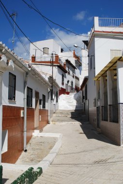 Townhouses along a steep town street near Velez Malaga, Spain. clipart