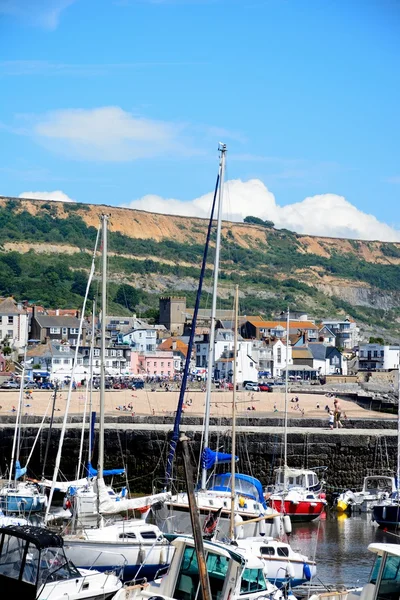 Boats and yachts moored in the harbour with views towards the beach and town, Lyme Regis. — Stock Photo, Image