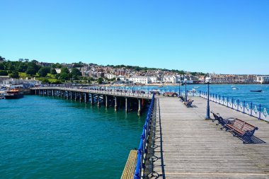 View along the Victorian pier towards the beach and town, Swanage. clipart
