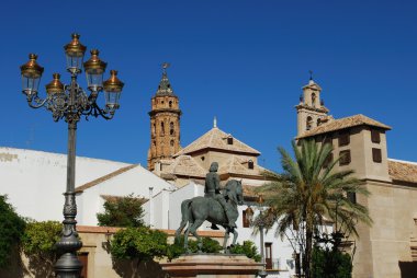 Plaza Guerrero Munoz with the tower of San Sebastian tower and Encarnation convent centre with statue of Fernando I, Antequera, Spain. clipart
