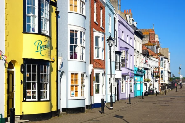 Brightly painted buildings and shop fronts alongside the harbour, Weymouth.