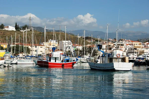 View of fishing boats and yachts moored in the harbour with town buildings to the rear, Caleta de Velez, Spain. — Stock Photo, Image