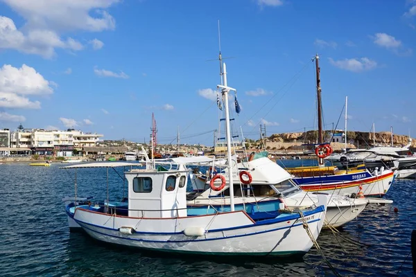 Barcos de pesca tradicionales en el puerto con restaurantes frente al mar en la parte trasera, Hersonissos, Creta . —  Fotos de Stock