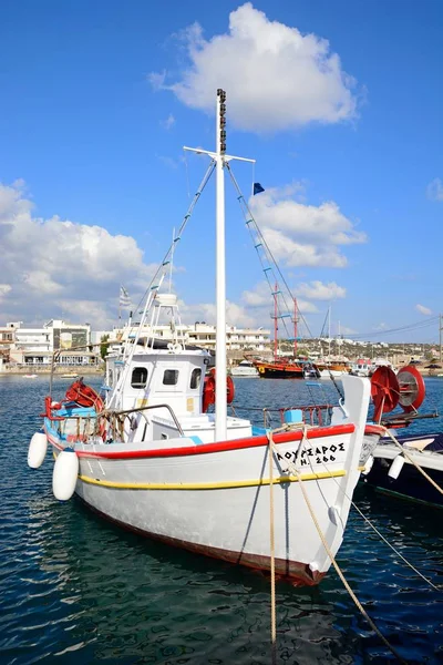 Barco de pesca tradicional en el puerto con restaurantes frente al mar en la parte trasera, Hersonissos, Creta . — Foto de Stock