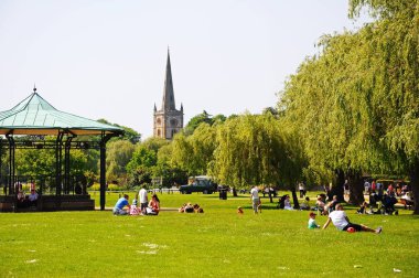 Bandstand in Bancroft Gardens with the Holy Trinity Church spire to the rear, Stratford-Upon-Avon, UK. clipart