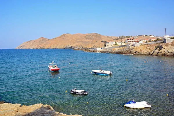 Kis csónakok Horgonyzott az öbölben, kilátással a sziklás partvidék, Panormos, Crete. — Stock Fotó