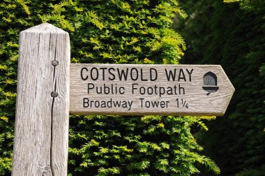 Wooden Cotswold Way signpost giving directions to Broadway Tower, Broadway, UK. clipart