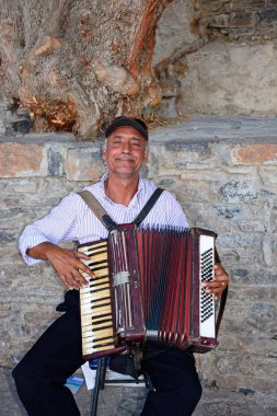 Bağlantı noktası, Elounda, Girit'te piyano akordeon oynarken Girit adam.