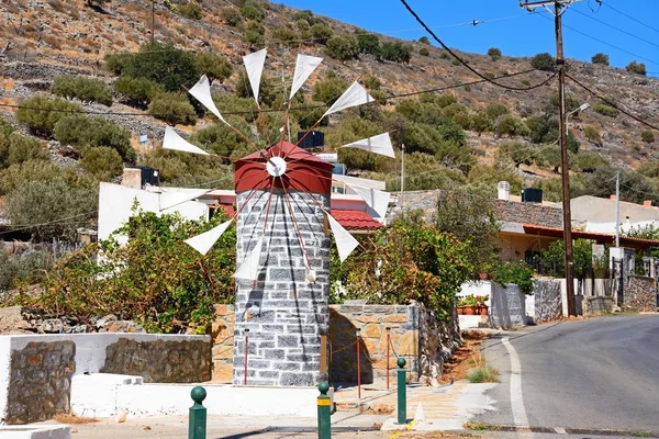 Pequeño molino de viento de piedra a lo largo de una calle del pueblo cerca de Elounda, Creta . — Foto de Stock