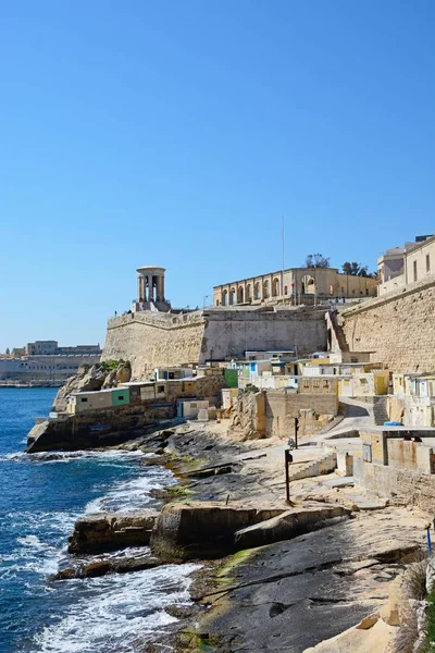 Vista a lo largo del paseo marítimo hacia el campanario Siege Memorial y los arcos de los Jardines del Barrakka Inferior, La Valeta, Malta . — Foto de Stock
