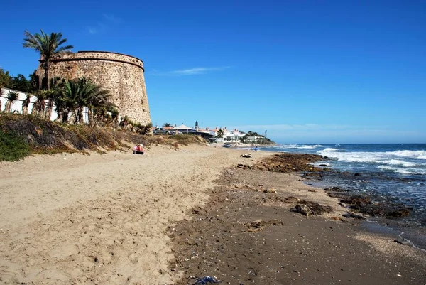 Zobrazit podél pláže Playa de las Canas beach s staré rozhledny na levé straně, Marbessa, Marbella, Španělsko. — Stock fotografie