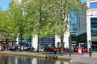 View towards the rear of the ICC with people relaxing in the foreground at Brindleyplace, Birmingham, UK. clipart