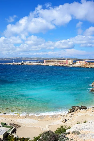 Costa rochosa com hotéis e terminal de ferry para a parte traseira, Paradise Bay, Malta . — Fotografia de Stock