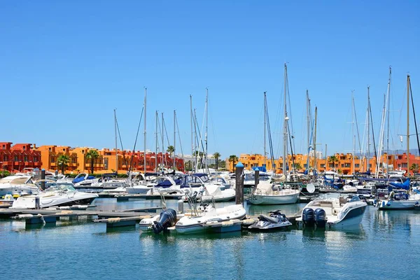Luxusní jachty a motorové čluny kotvící v přístavu s apartmány dozadu, Portimao, Portugalsko. — Stock fotografie