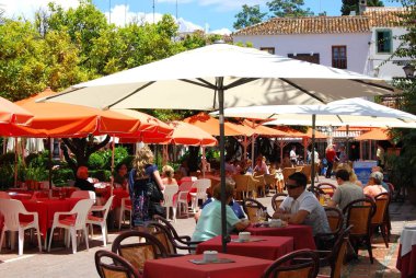 Portakal Meydanı, Marbella, İspanya 'daki kaldırım kafelerinde dinlenen turistler.