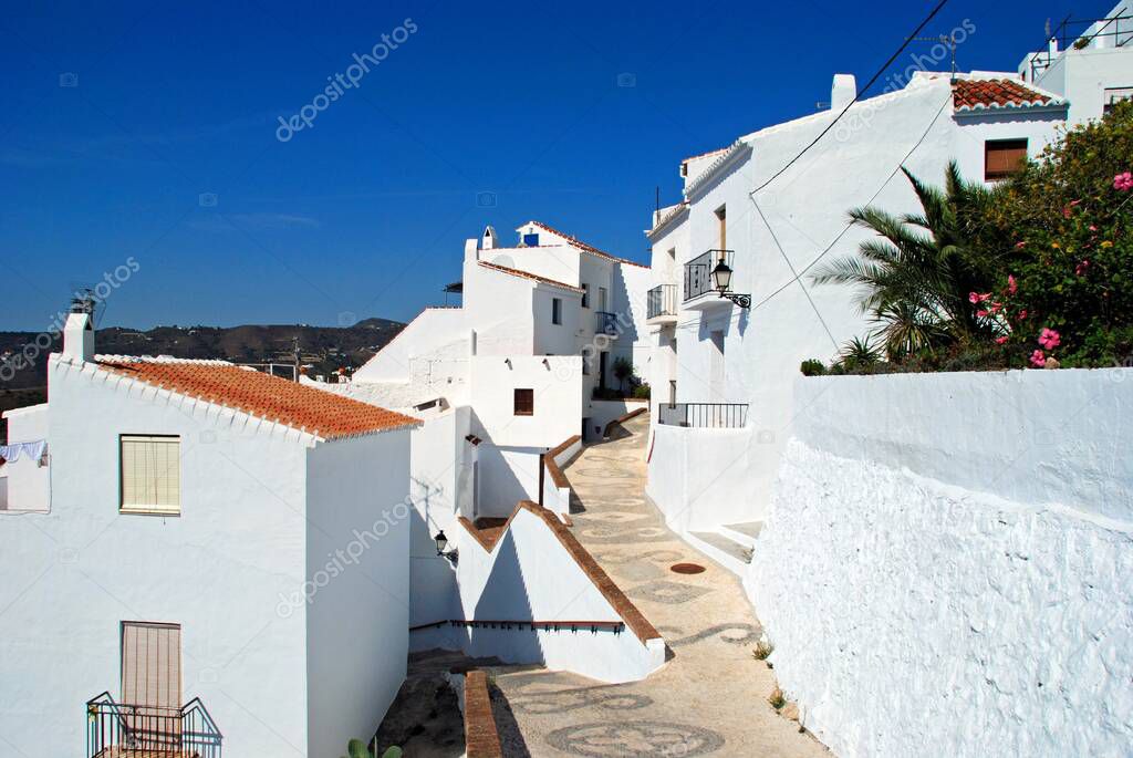 View along a whitewashed village street, Frigiliana, Costa del Sol, Malaga Province, Andalucia, Spain.
