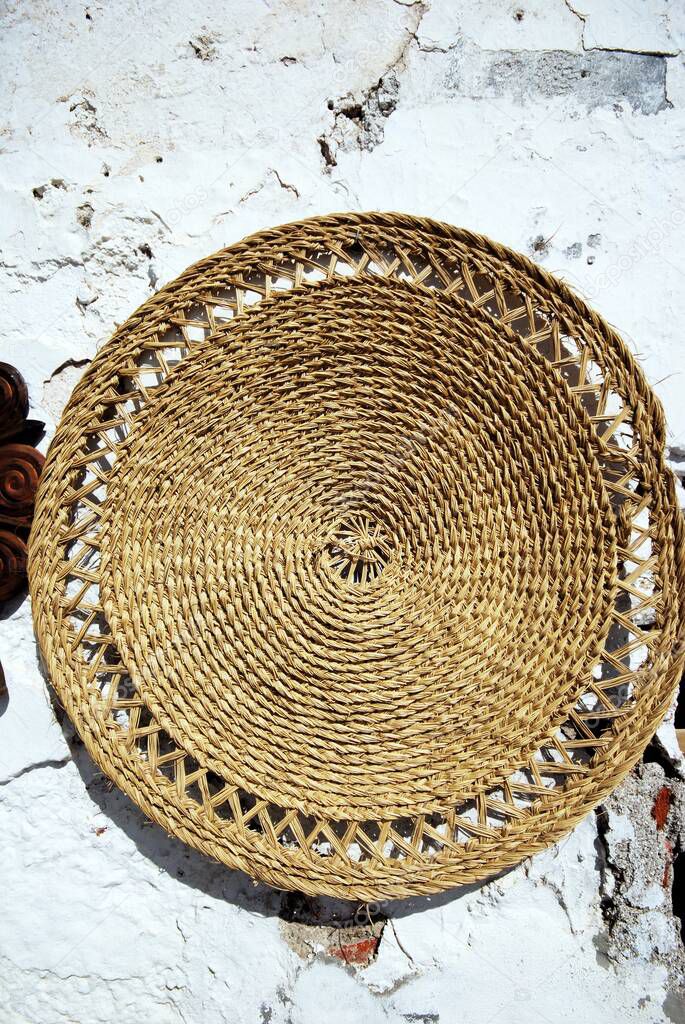 Wickerwork mat on a wall in the village centre, Frigiliana, Costa del Sol, Malaga Province, Andalucia, Spain.