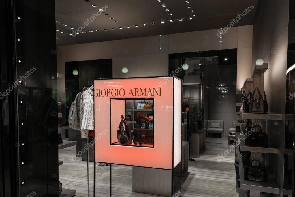 Milan, Italy - October 9, 2016: Shop window of a Giorgio Armani shop in Milan - Galleria Vittorio Emanuele II, Italy. Few days after Milan Fashion Week. Fall Winter 2017 Collection. Brand of Armani fashion house founded in 1975 by Giorgio Armani