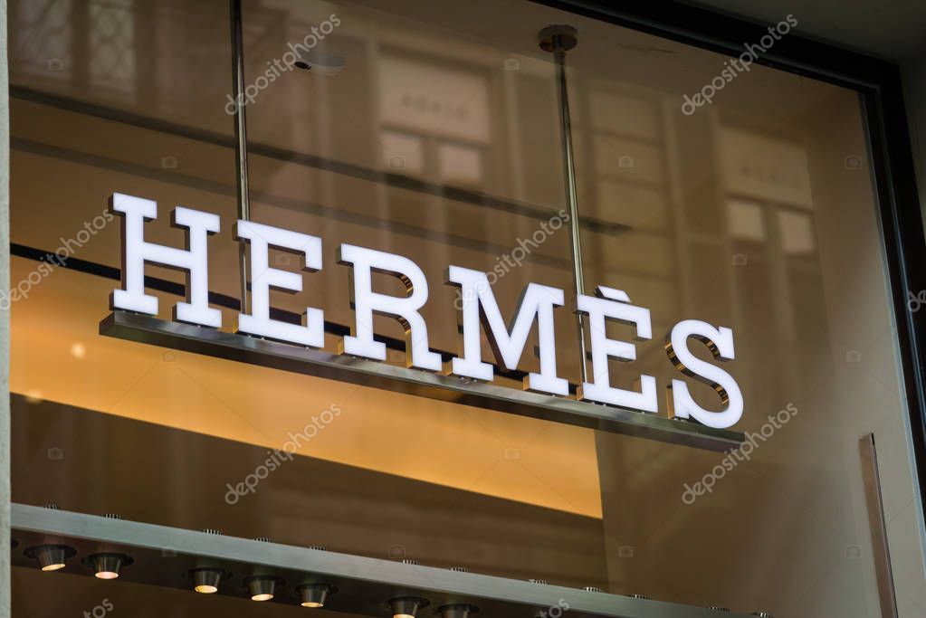 Milan, Italy - February 28, 2017: Shop window of a Hermes shop in Milan - Montenapoleone area, Italy. Few days after Milan Fashion Week. Spring Summer 2017 Collection. Hermes logo