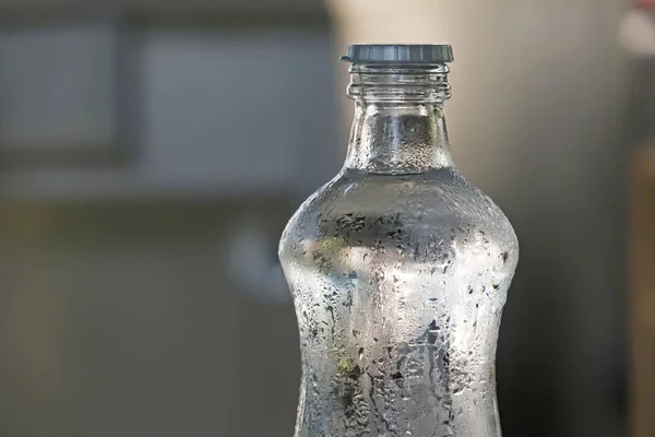 drinkable cold water in a glass bottle