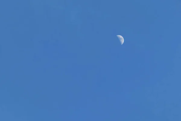 half moon at the blue sky