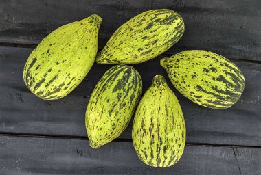 küçük kavun bir bıçak ile kesmek, olgunlaşmamış bir yemek kavun, olgunlaşmamış küçük kavun,