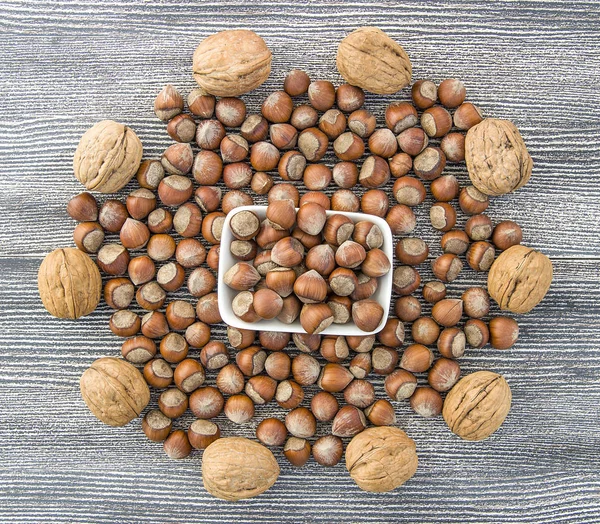 walnut and shelled hazelnut pictures side by side in a separate platestanding side by side in separate plate of shelled hazelnuts and shelled walnuts pictures