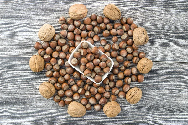 walnut and shelled hazelnut pictures side by side in a separate platestanding side by side in separate plate of shelled hazelnuts and shelled walnuts pictures