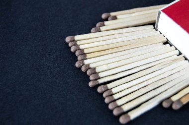 siyah bir arka plan ile bir kibrit kutusu ve bu maçta düzinelerce vardır,